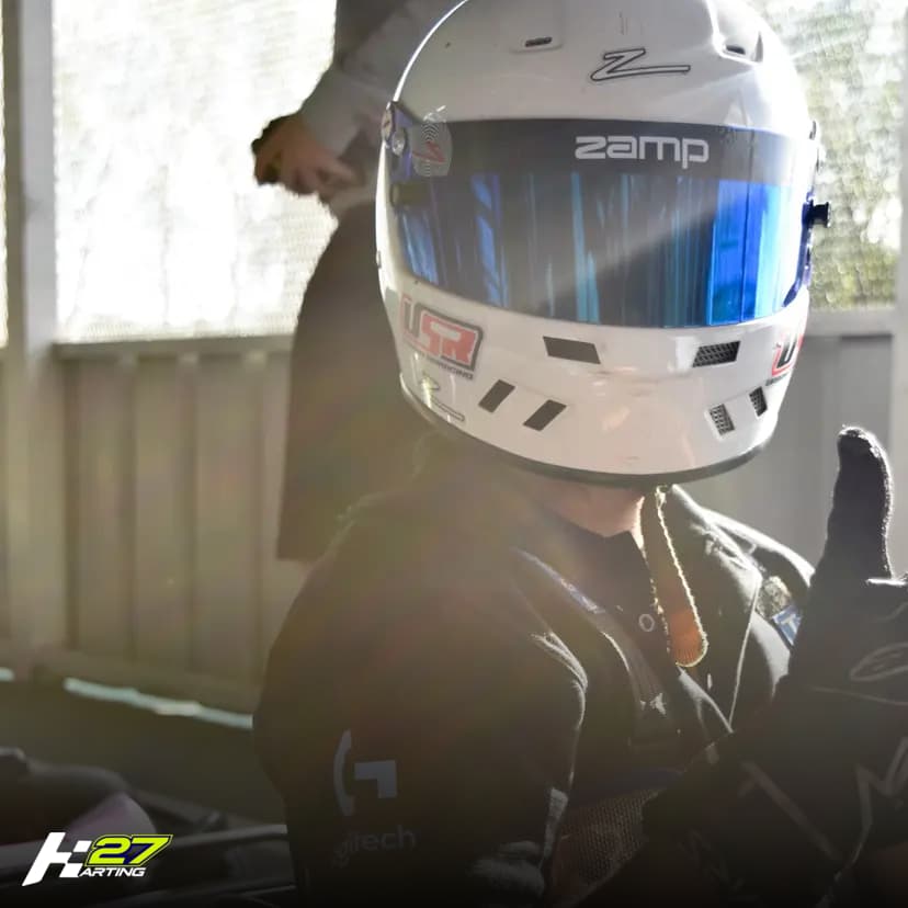 Piloto joven con casco profesional listo para correr en Karting 27